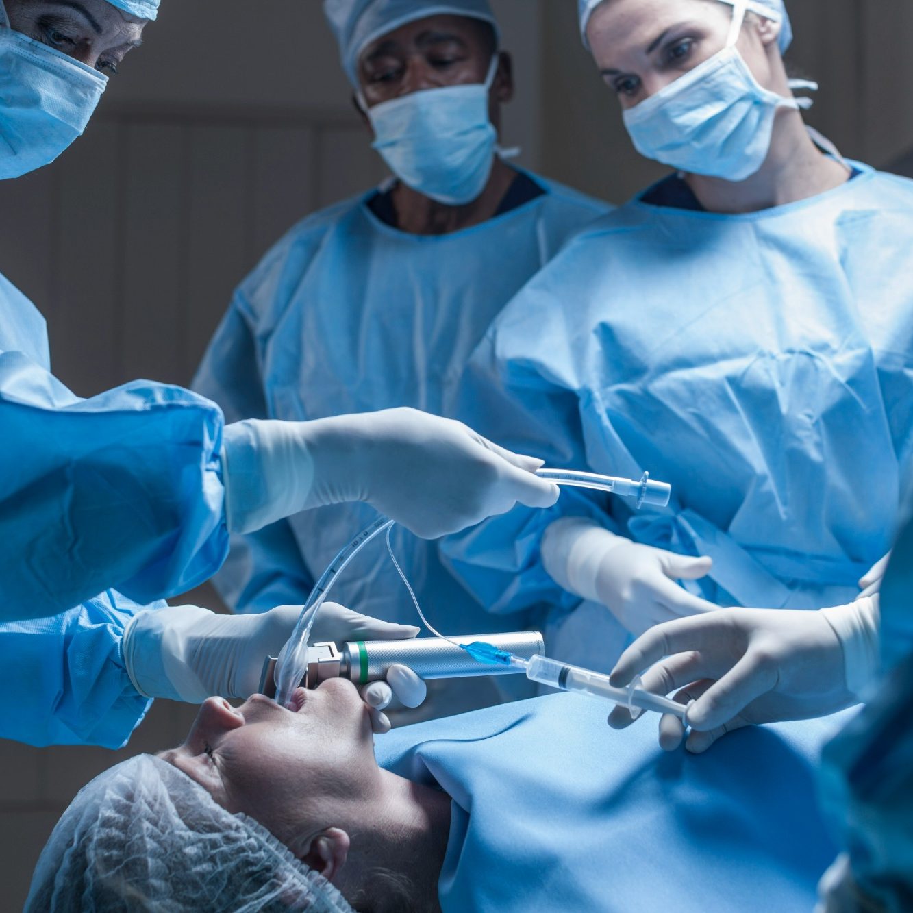Medical team performing surgery on a patient under anesthesia.