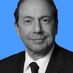A man in a suit with a slight smile against a blue background.
